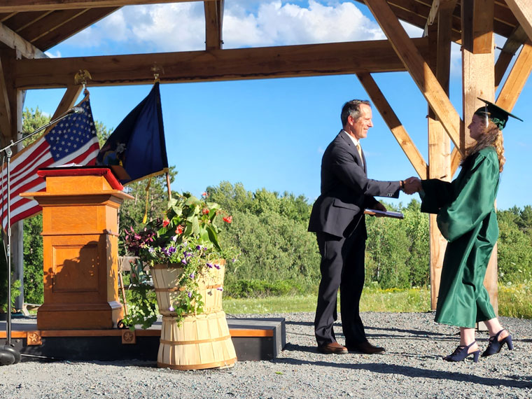 Head of School, Matt Newberg congratulates a new graduate