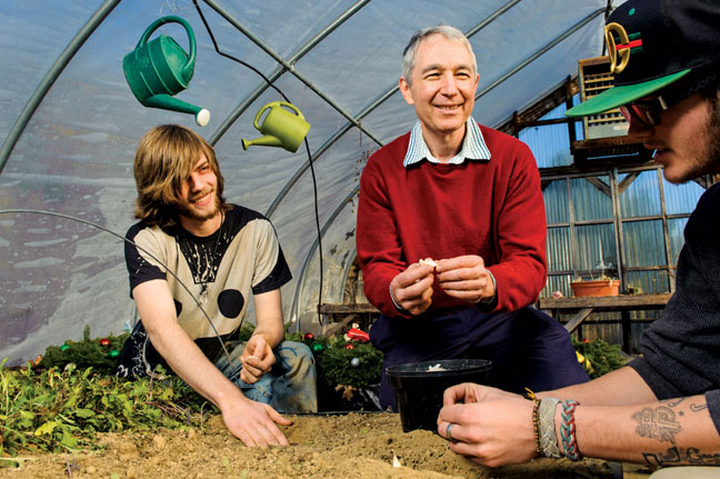 Innovative educator Emanuel Pariser working with students in greenhouse.